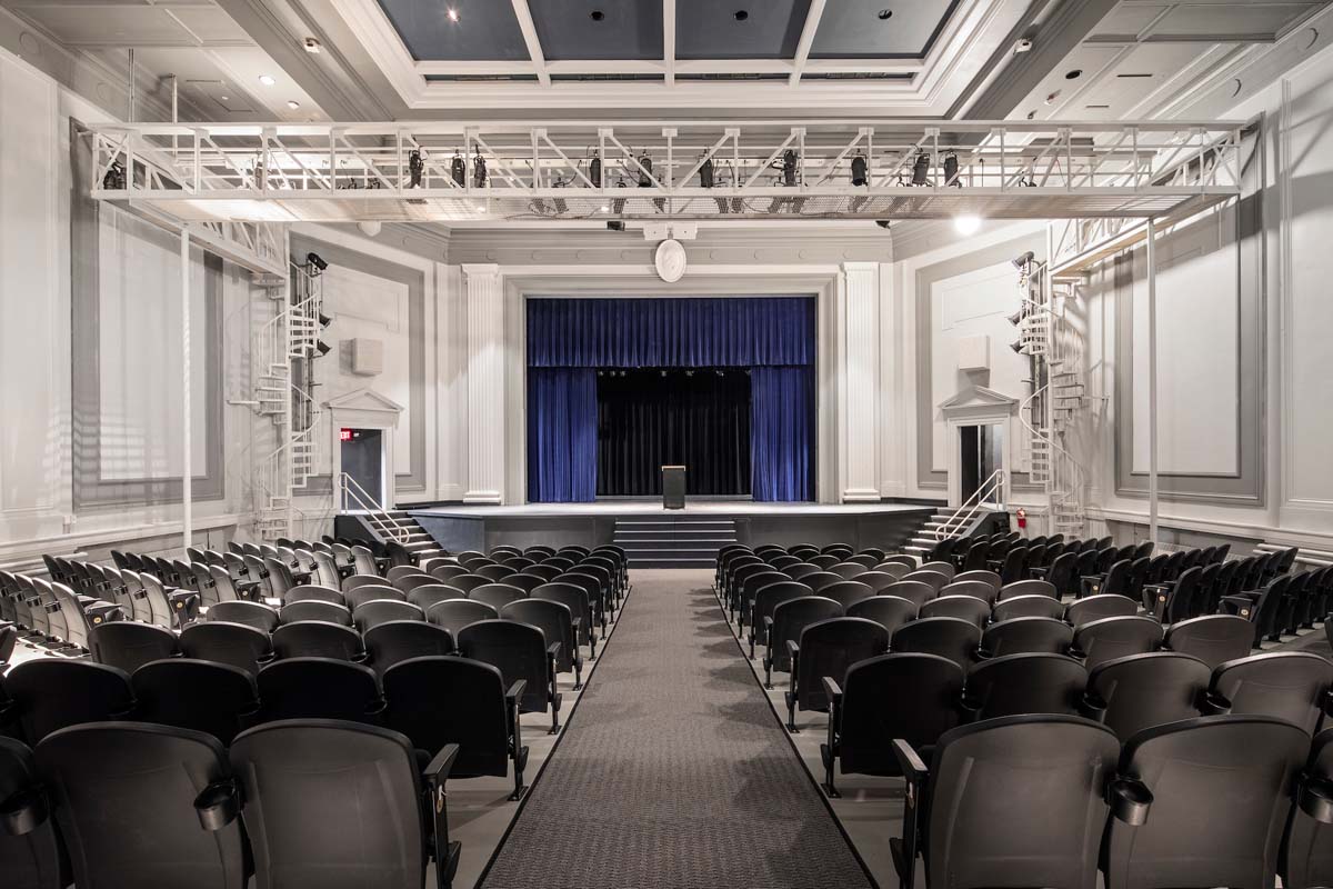 a large auditorium with rows of chairs