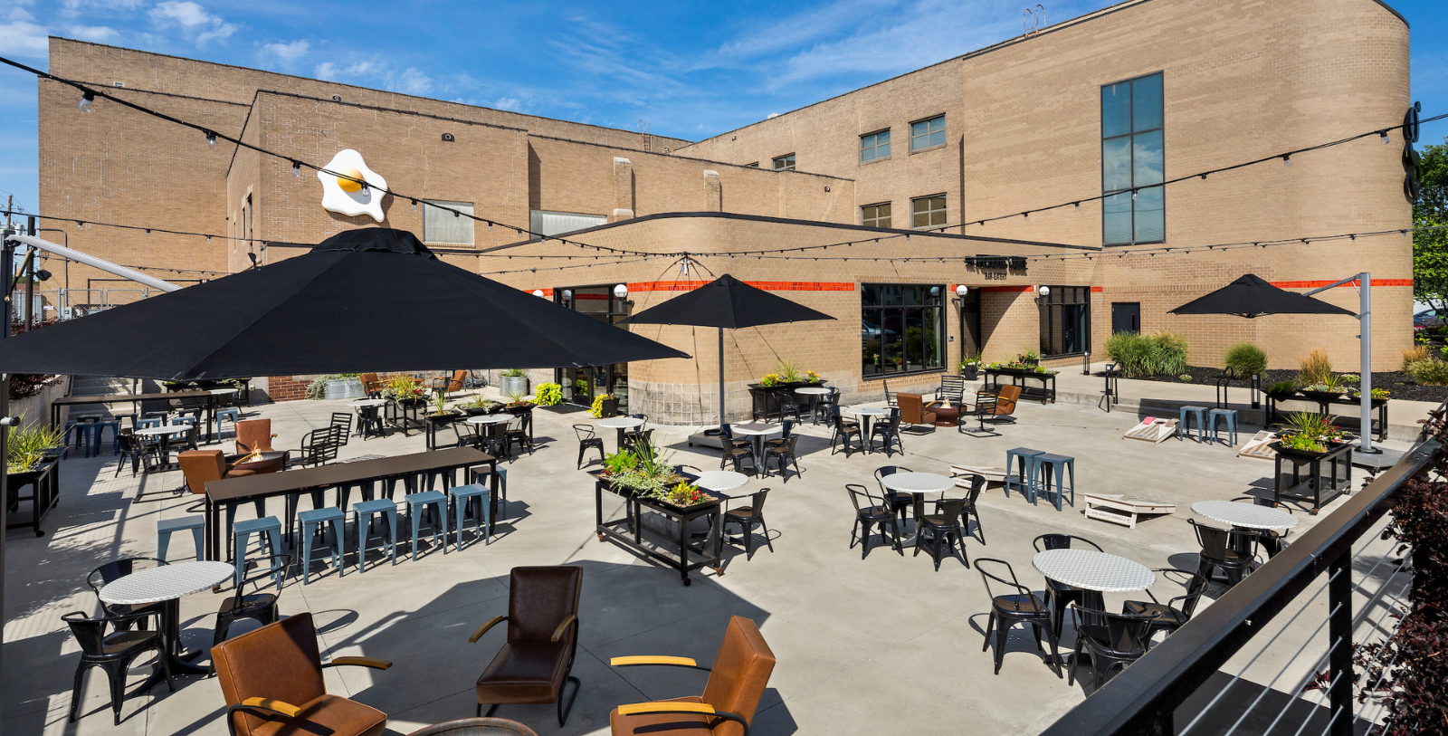 a patio with tables and chairs and umbrellas