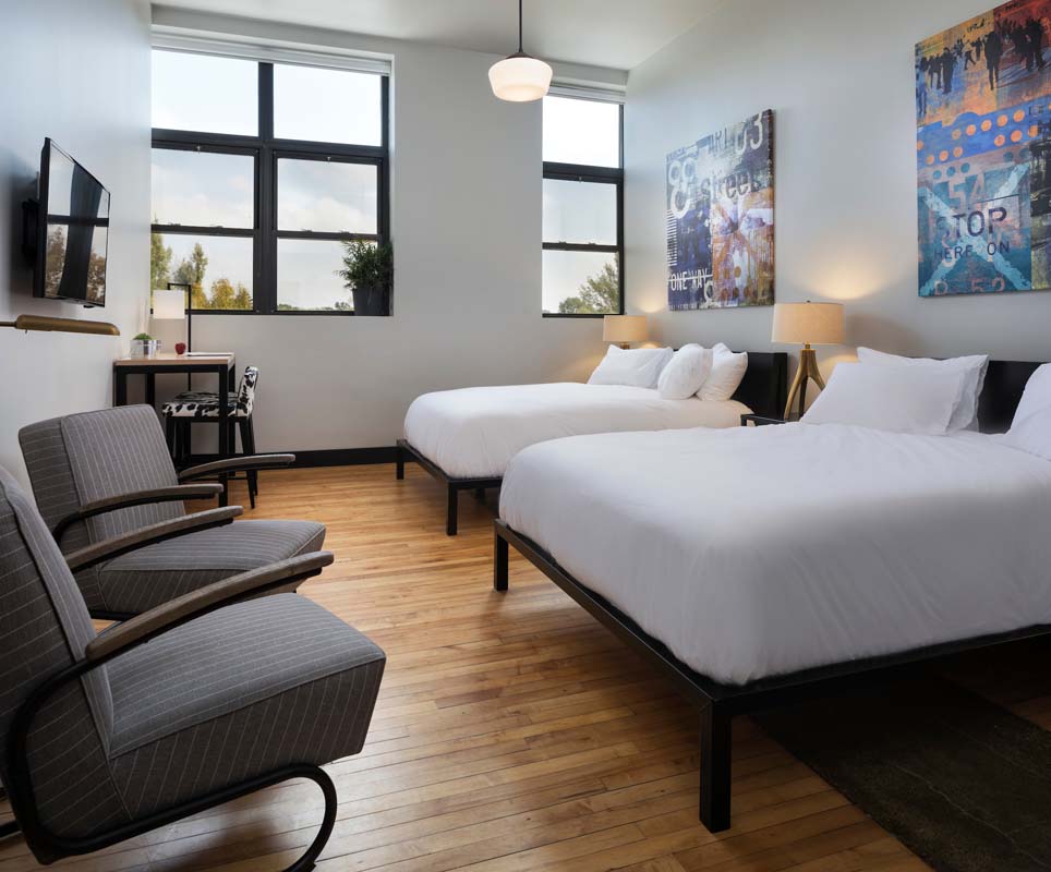 a room with two beds and a couch