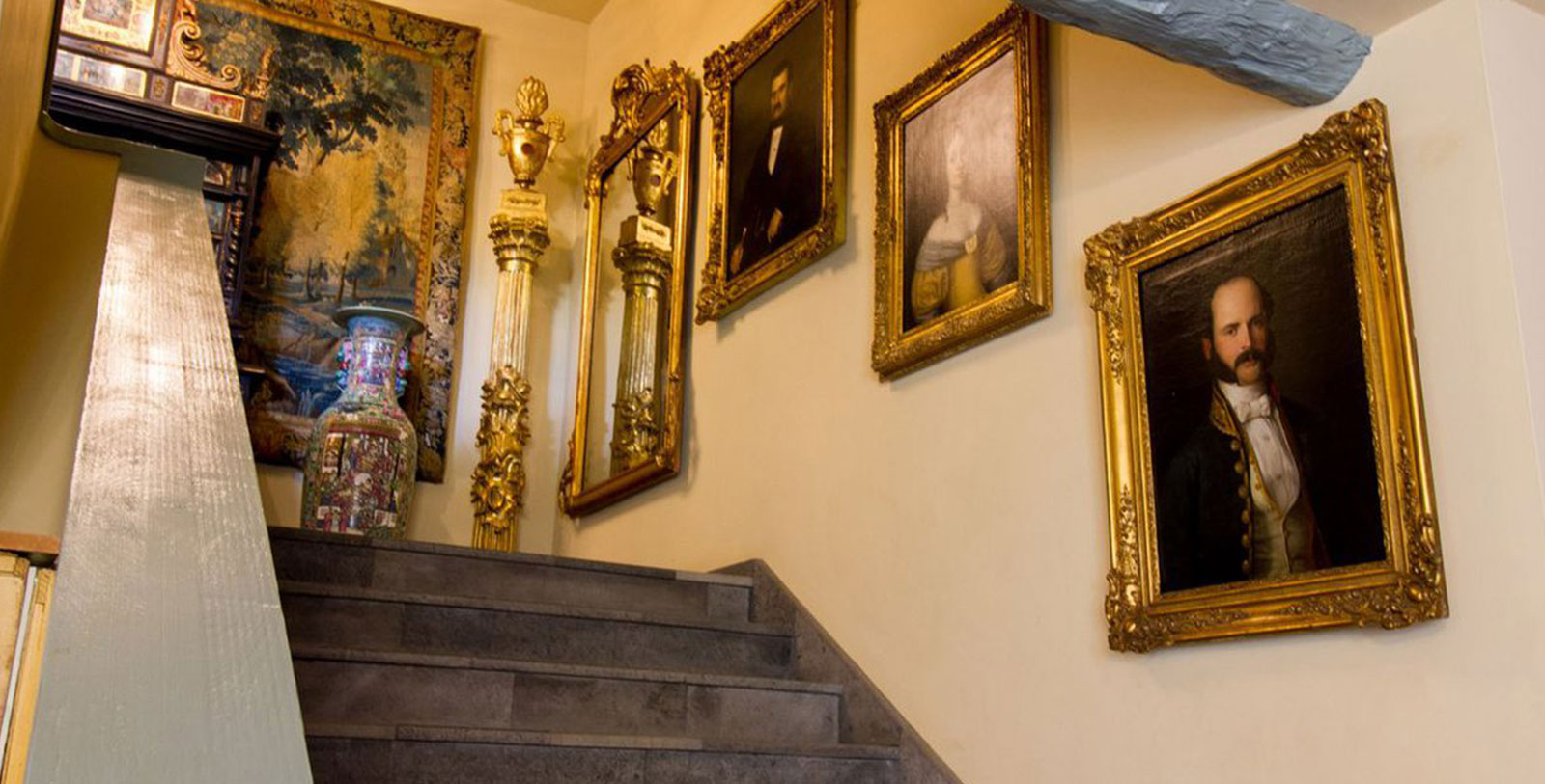 a staircase with a set of pictures on the wall