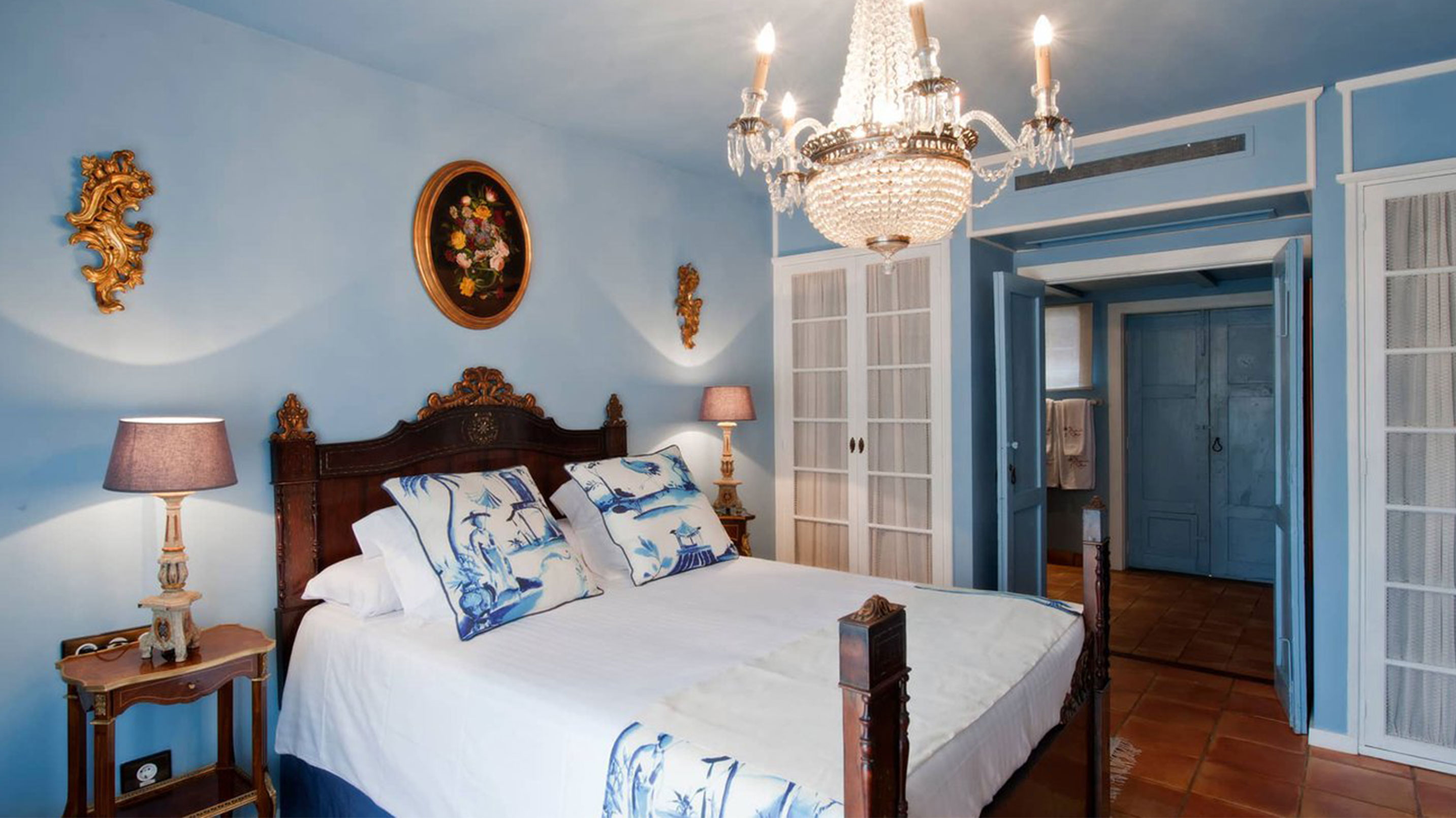 a bedroom with a chandelier and a bed