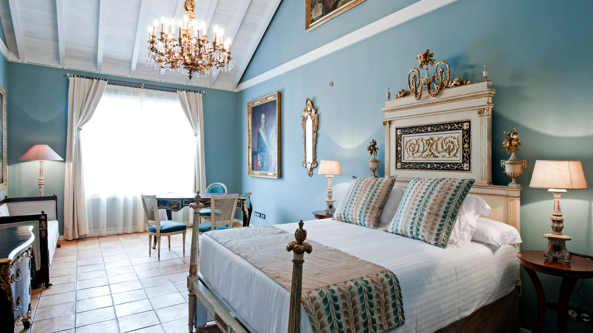 a bedroom with a bed and chandelier