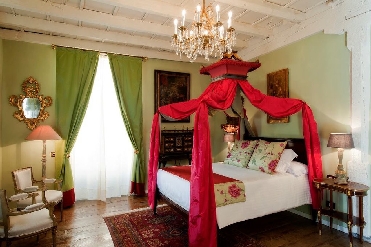 a bedroom with a canopy bed and chandelier