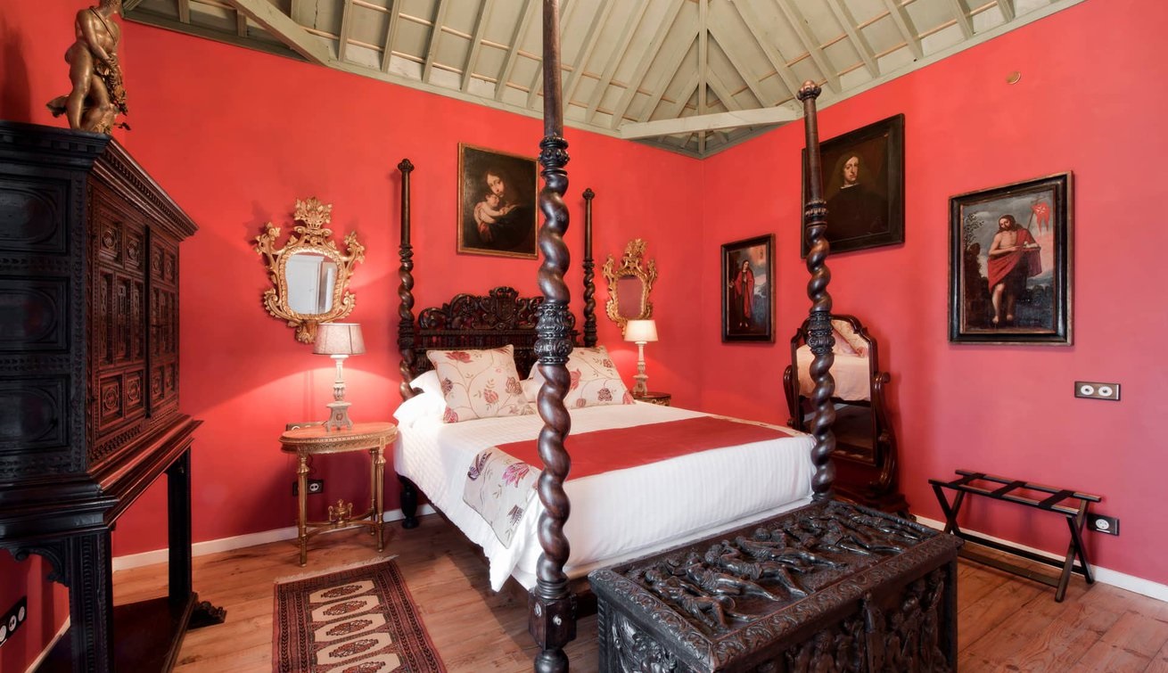 a room with a four poster bed