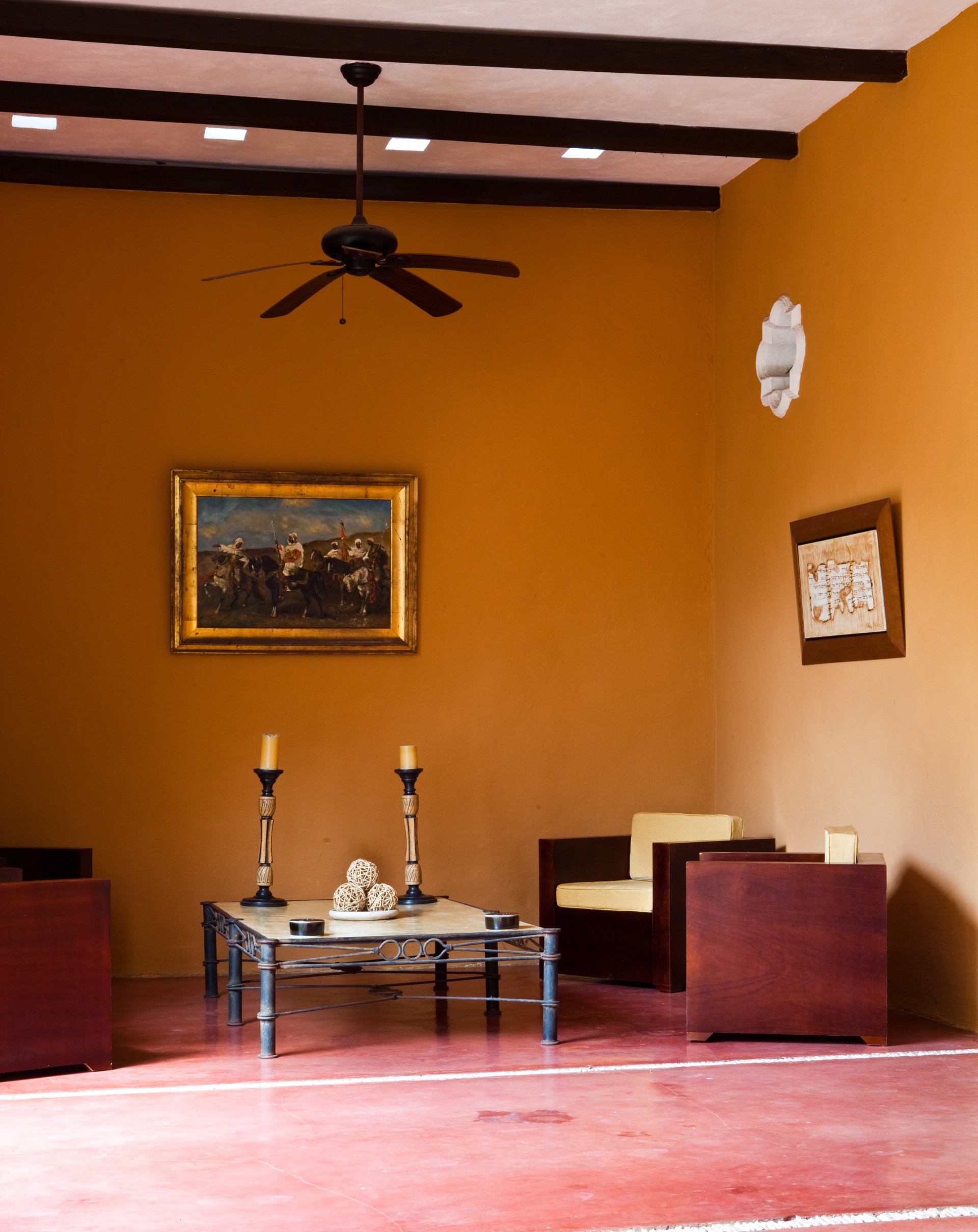 a room with a fan and a table