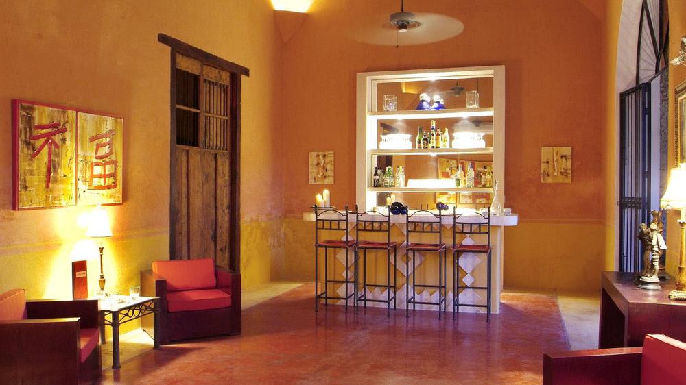 a bar with shelves and chairs in a room