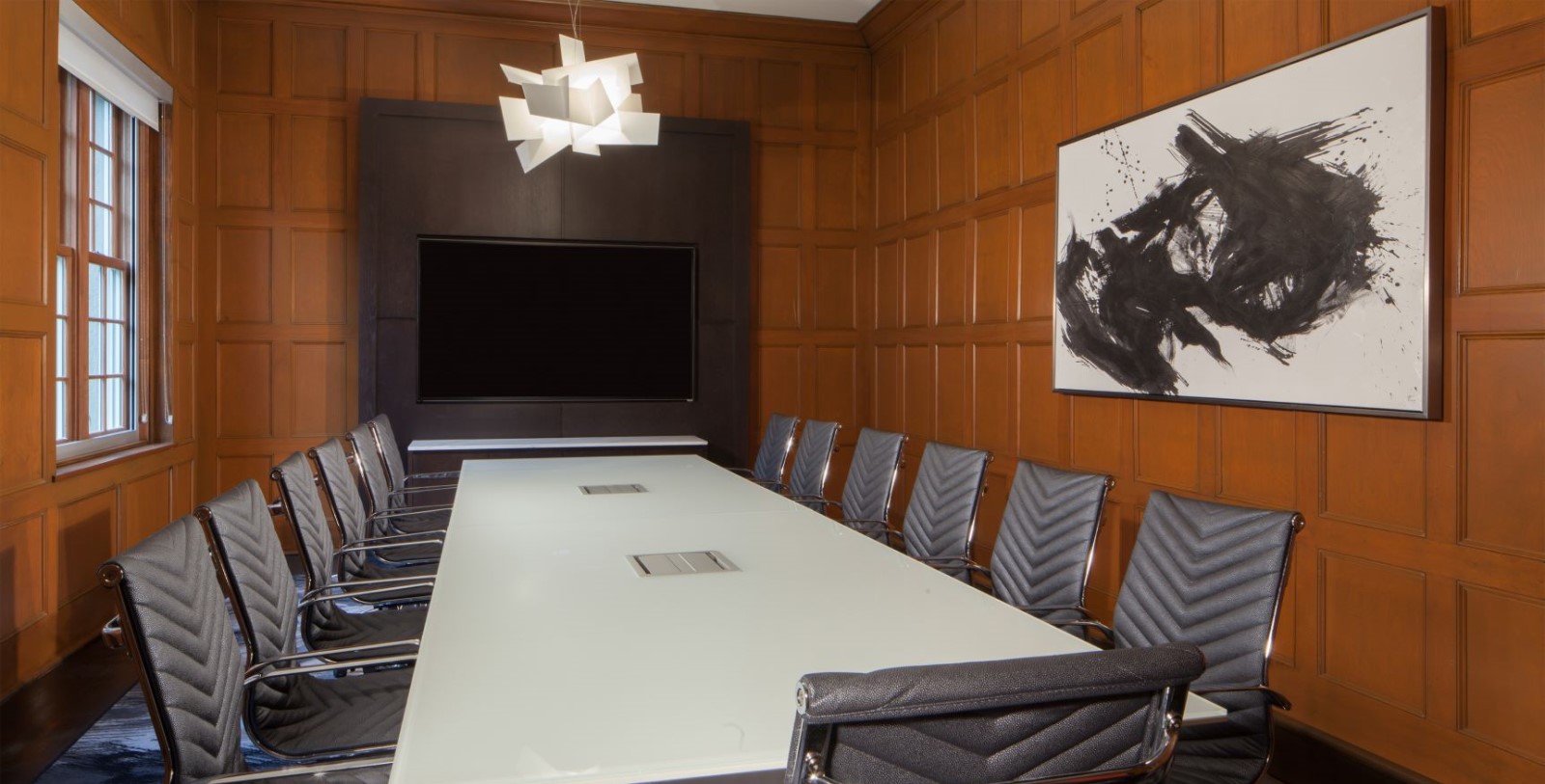 a conference room with a white table and chairs
