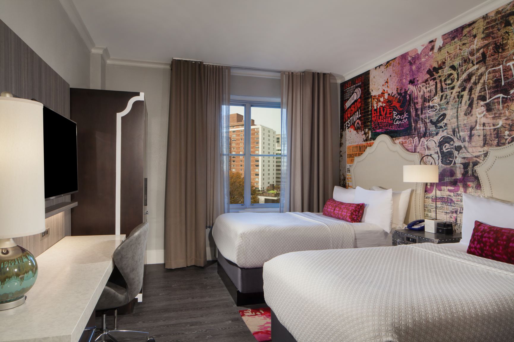 a room with two beds and a desk