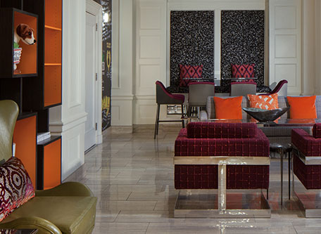 a room with a couch and chairs