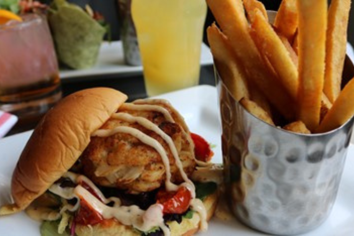 a plate of food with a bucket of fries