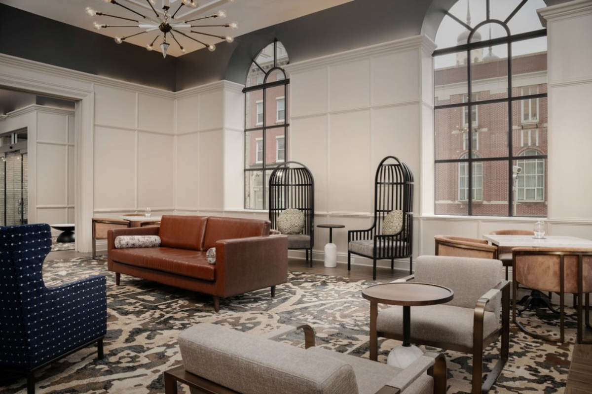 a room with a couch and chairs