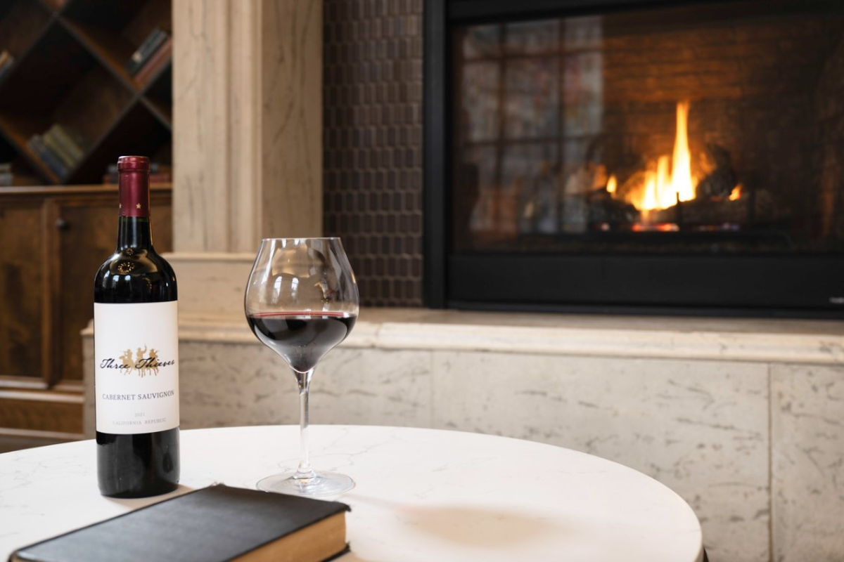 a wine bottle and a glass of wine on a table