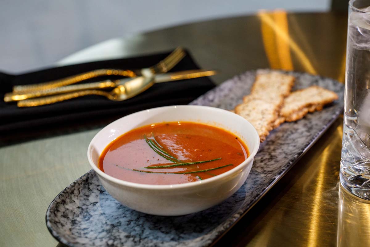 a bowl of soup and crackers on a plate