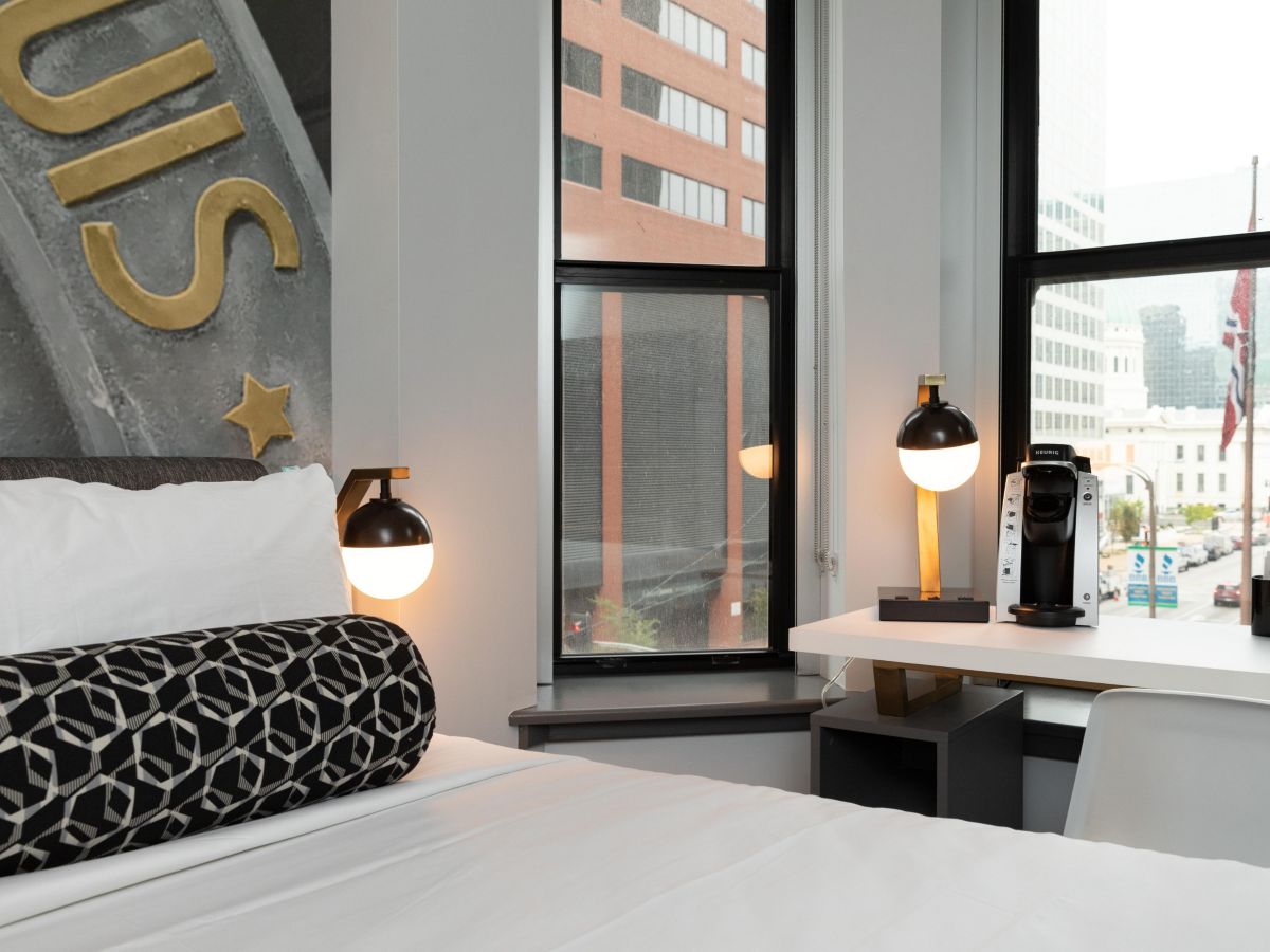 a bed with a coffee machine and a coffee maker