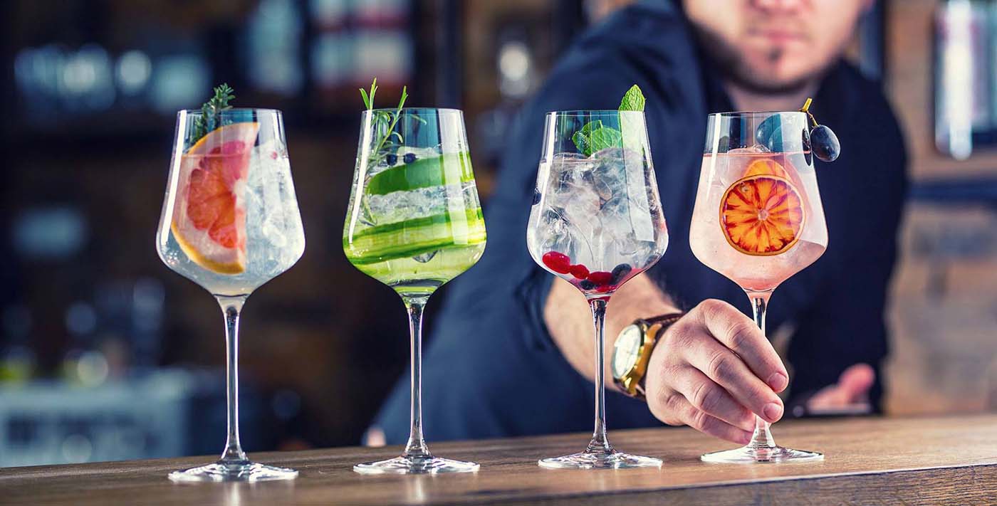 a person holding a glass of drinks