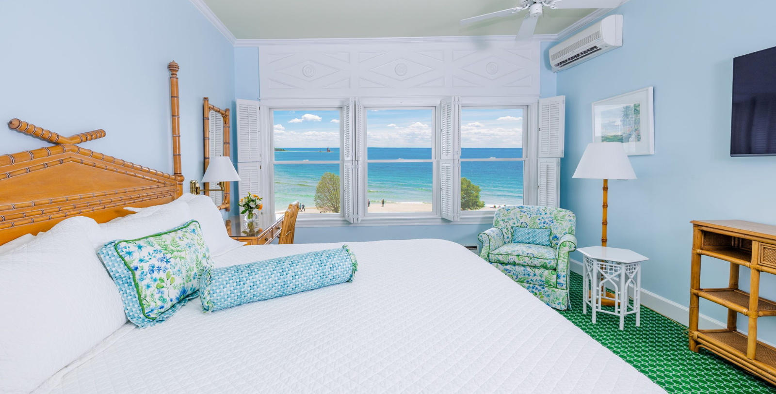 a bedroom with a large bed and a chair and a window