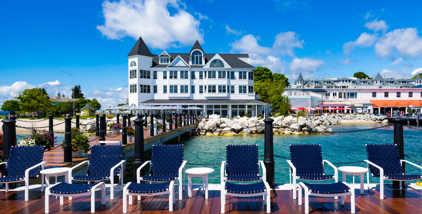 a group of chairs on a dock by a large building