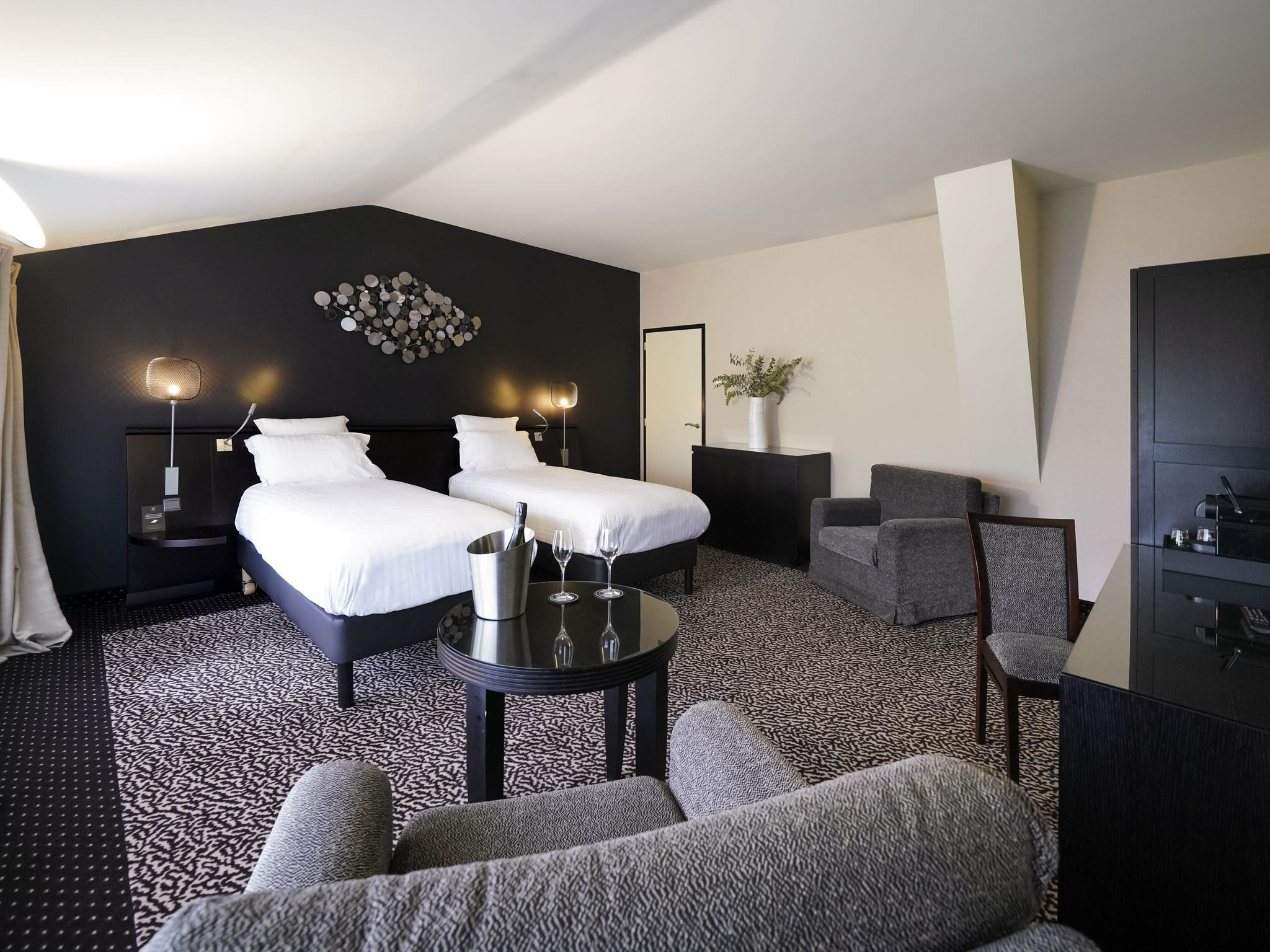 a room with two beds and a table