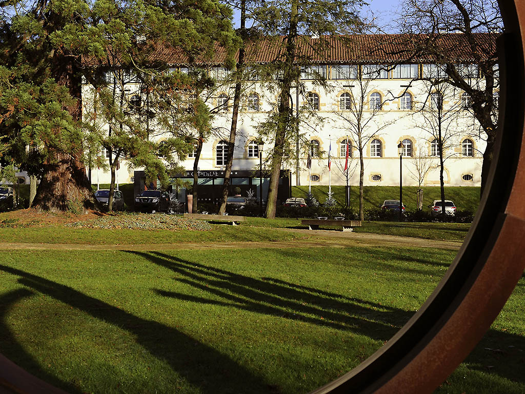 a building with trees and grass