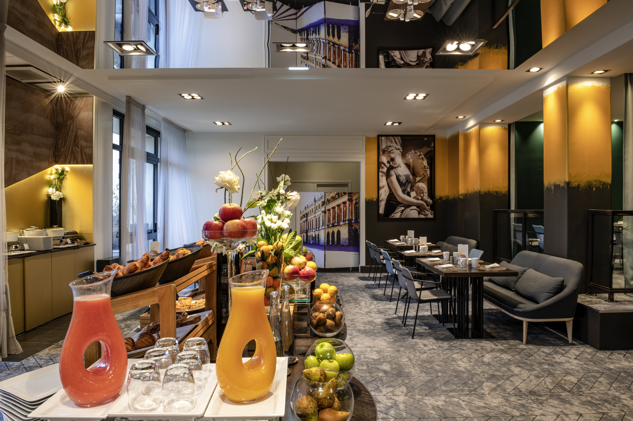 a room with tables and chairs and a table with food and drinks
