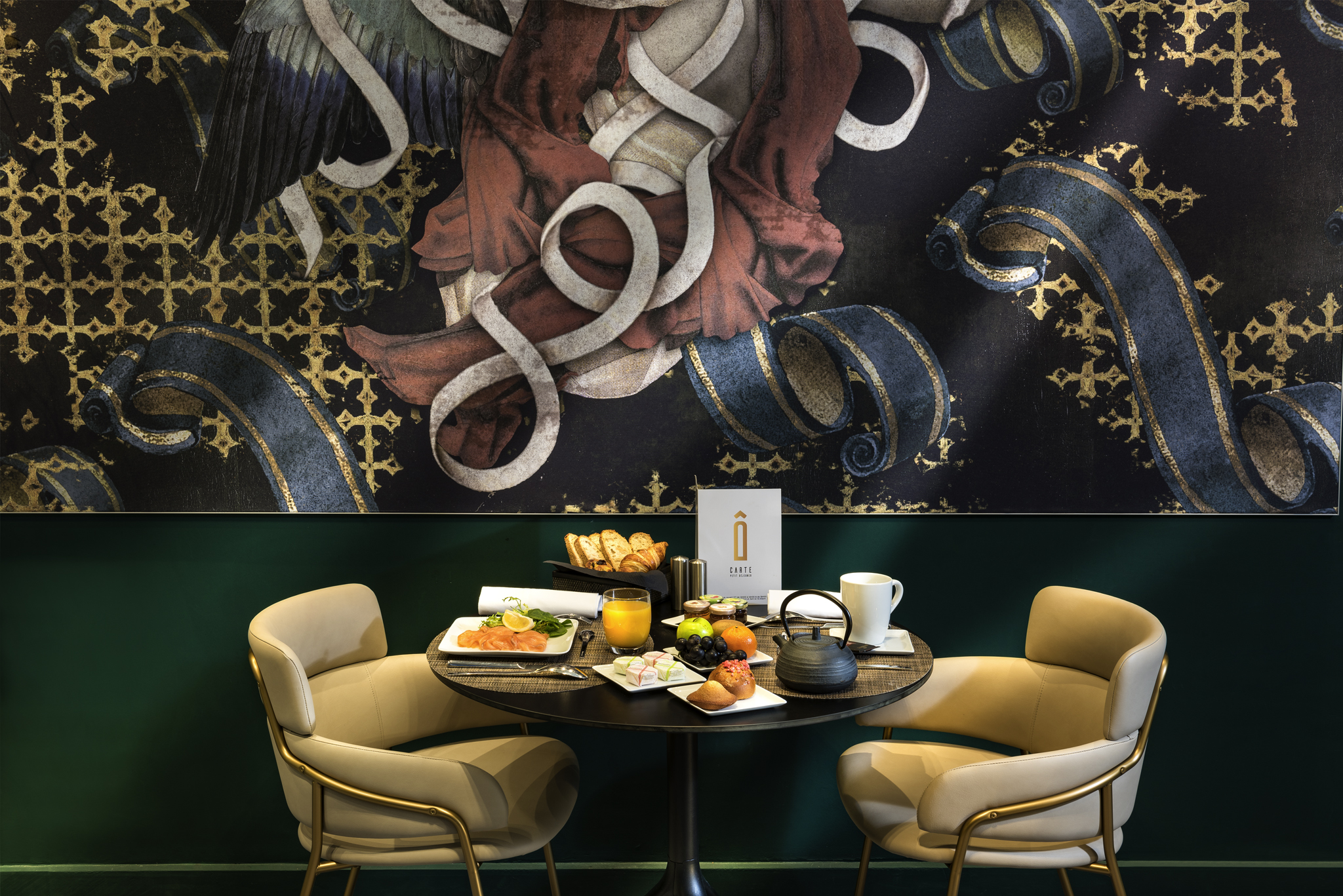 a table with food and chairs in front of a mural