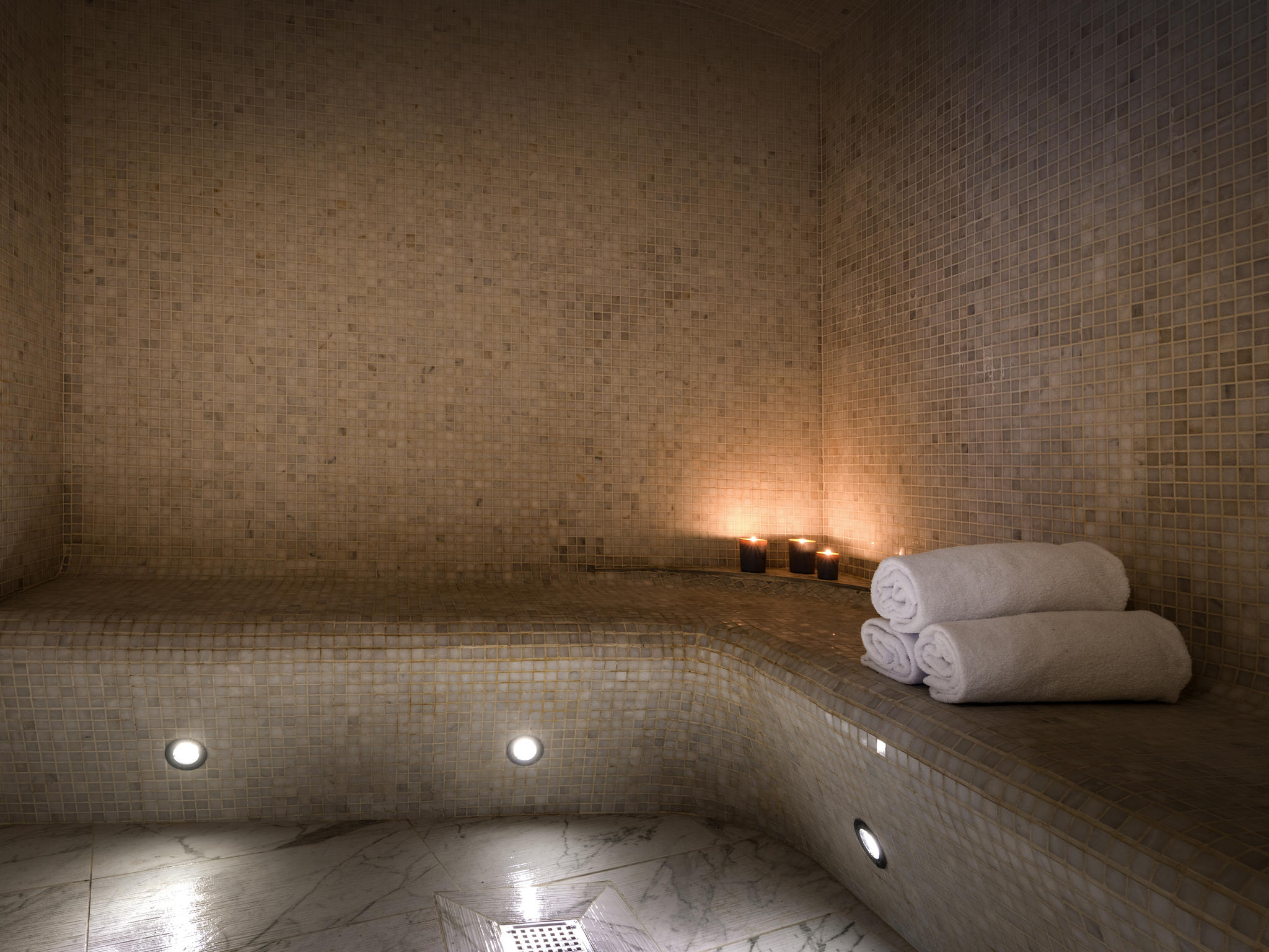 a bathtub with towels and candles