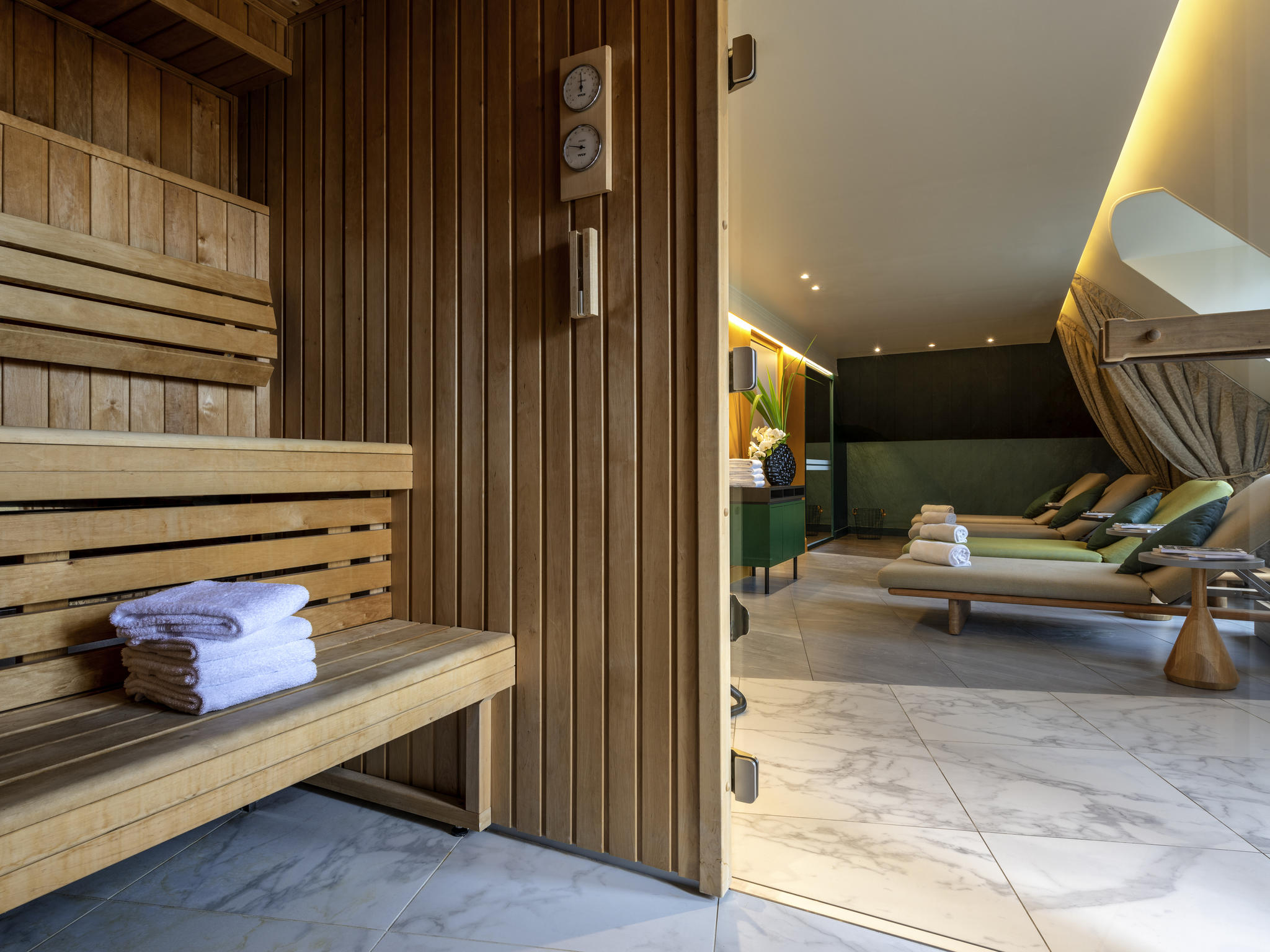 a room with a wooden bench and chairs