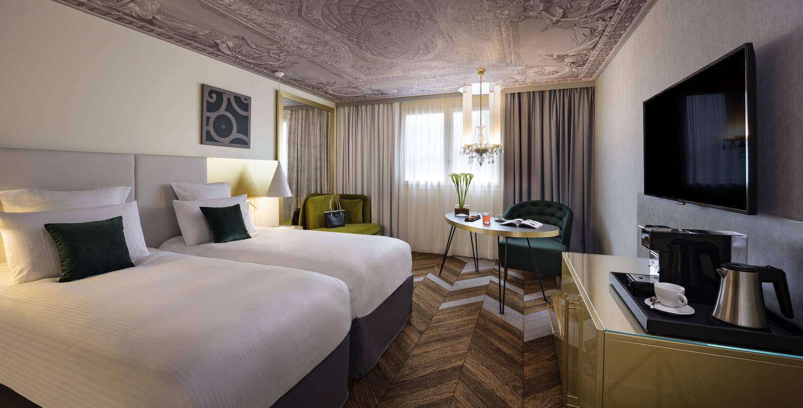 a room with two beds and a table