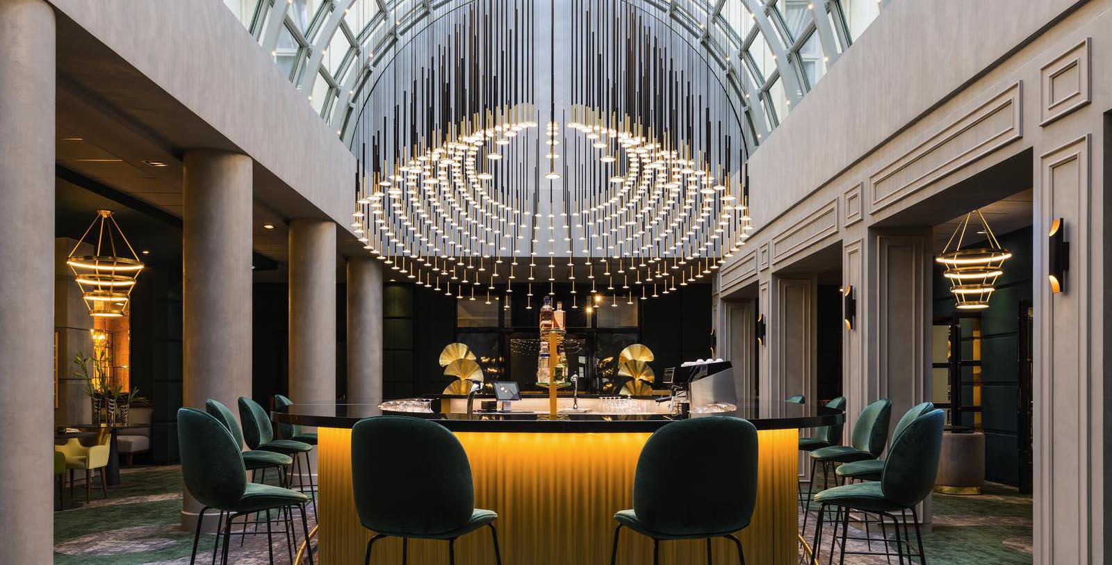 a bar with a chandelier and chairs