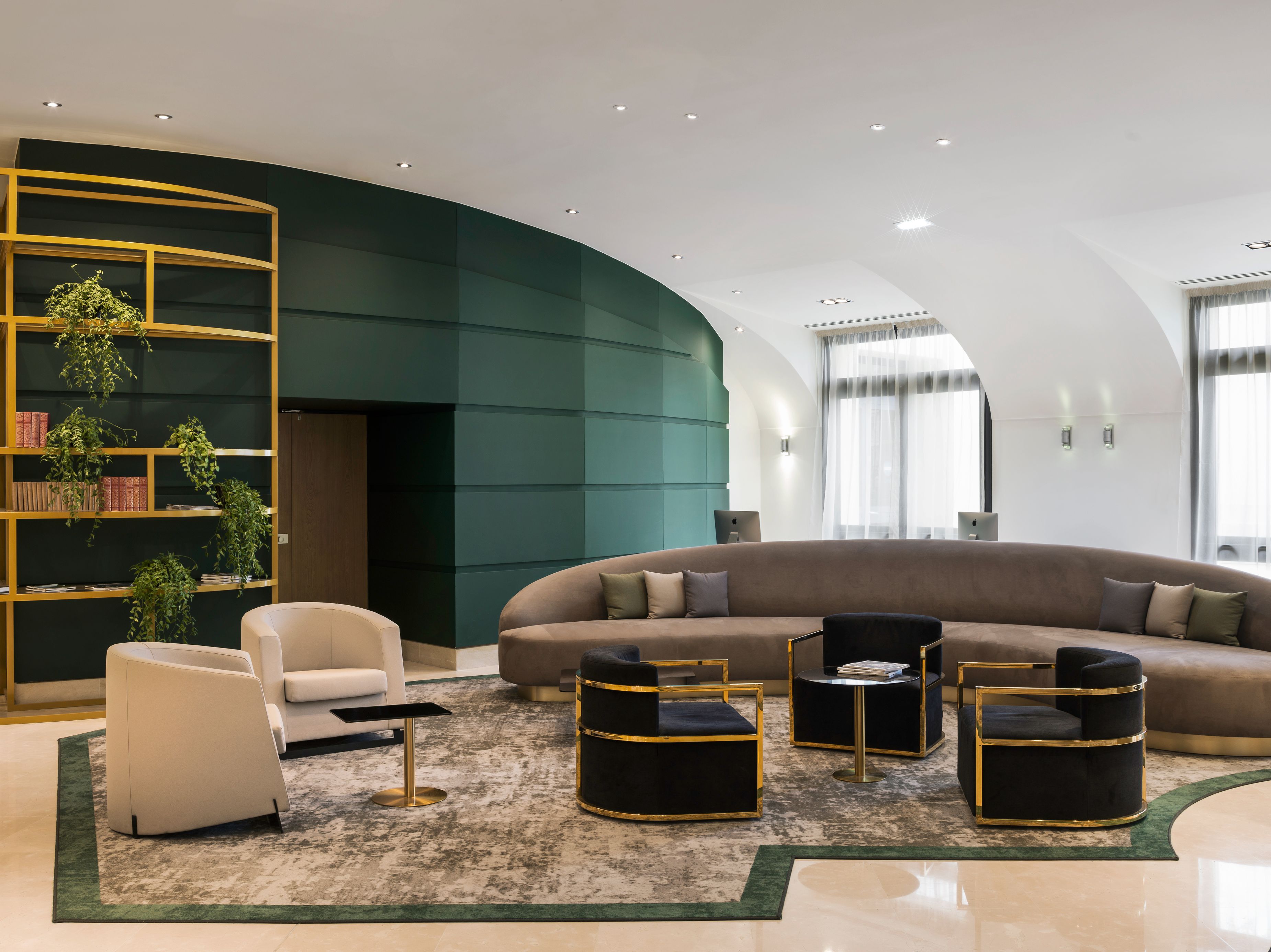 a room with a round couch and chairs