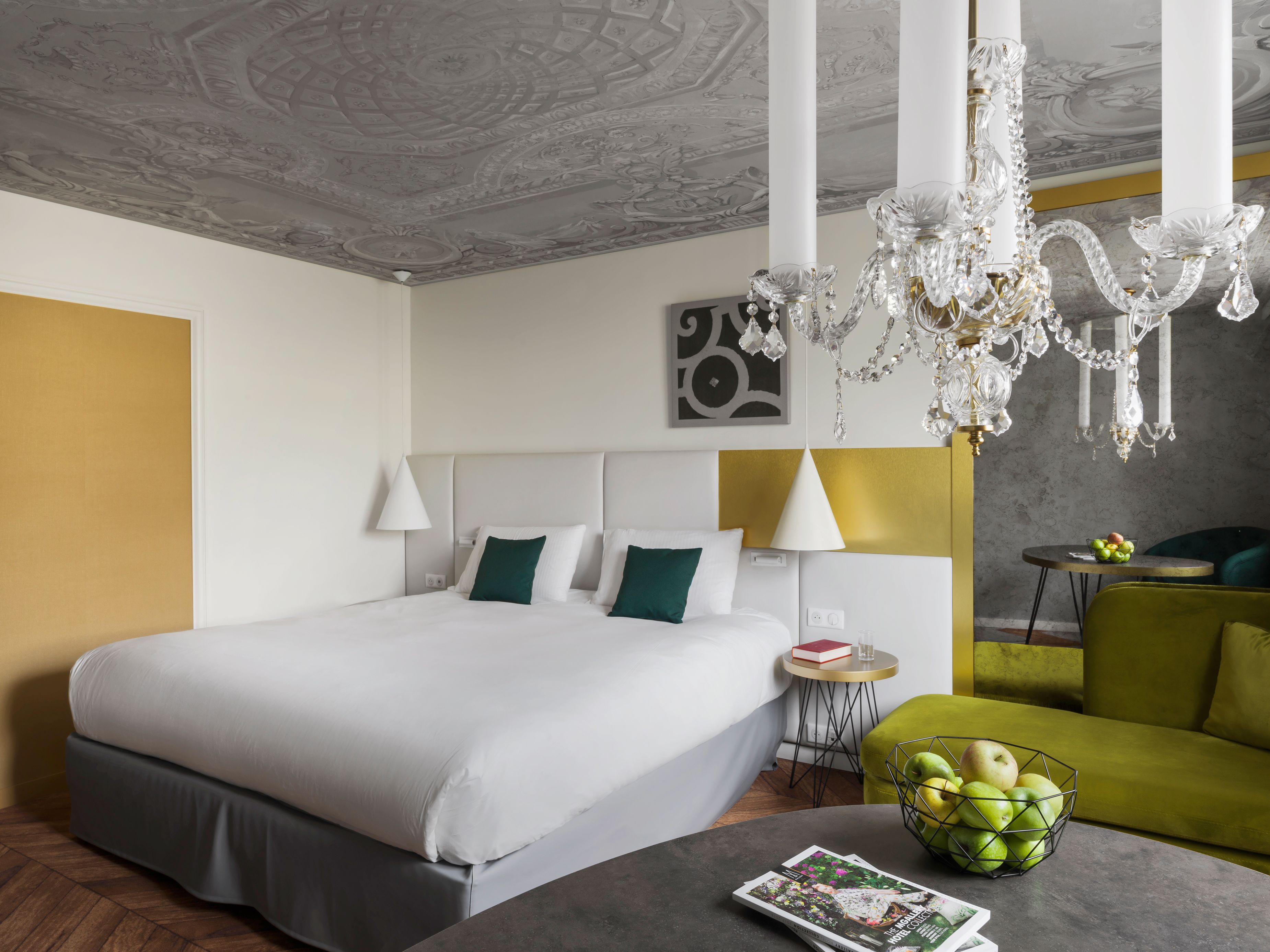 a bedroom with a bed and a chandelier