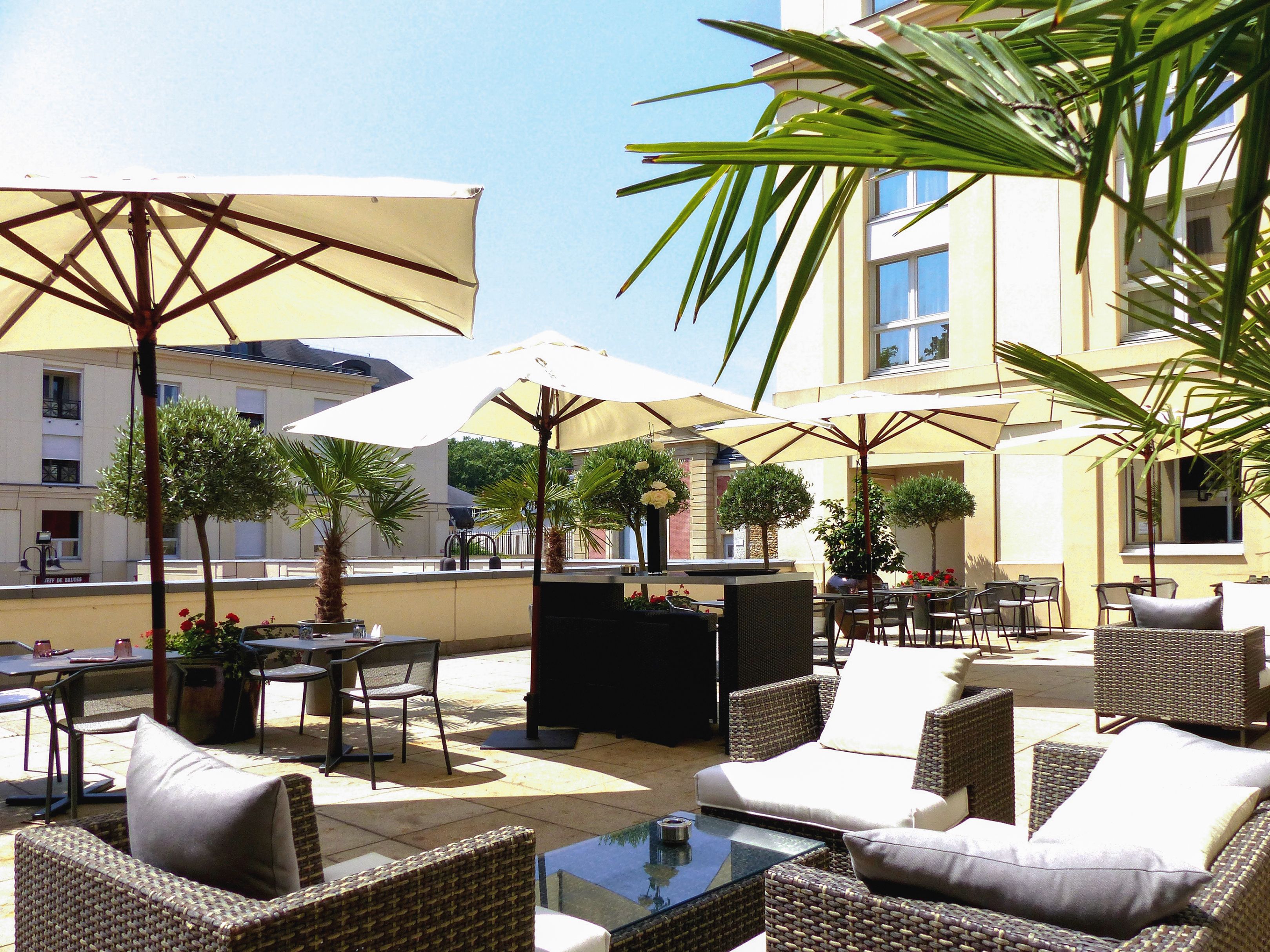 a patio with chairs and umbrellas