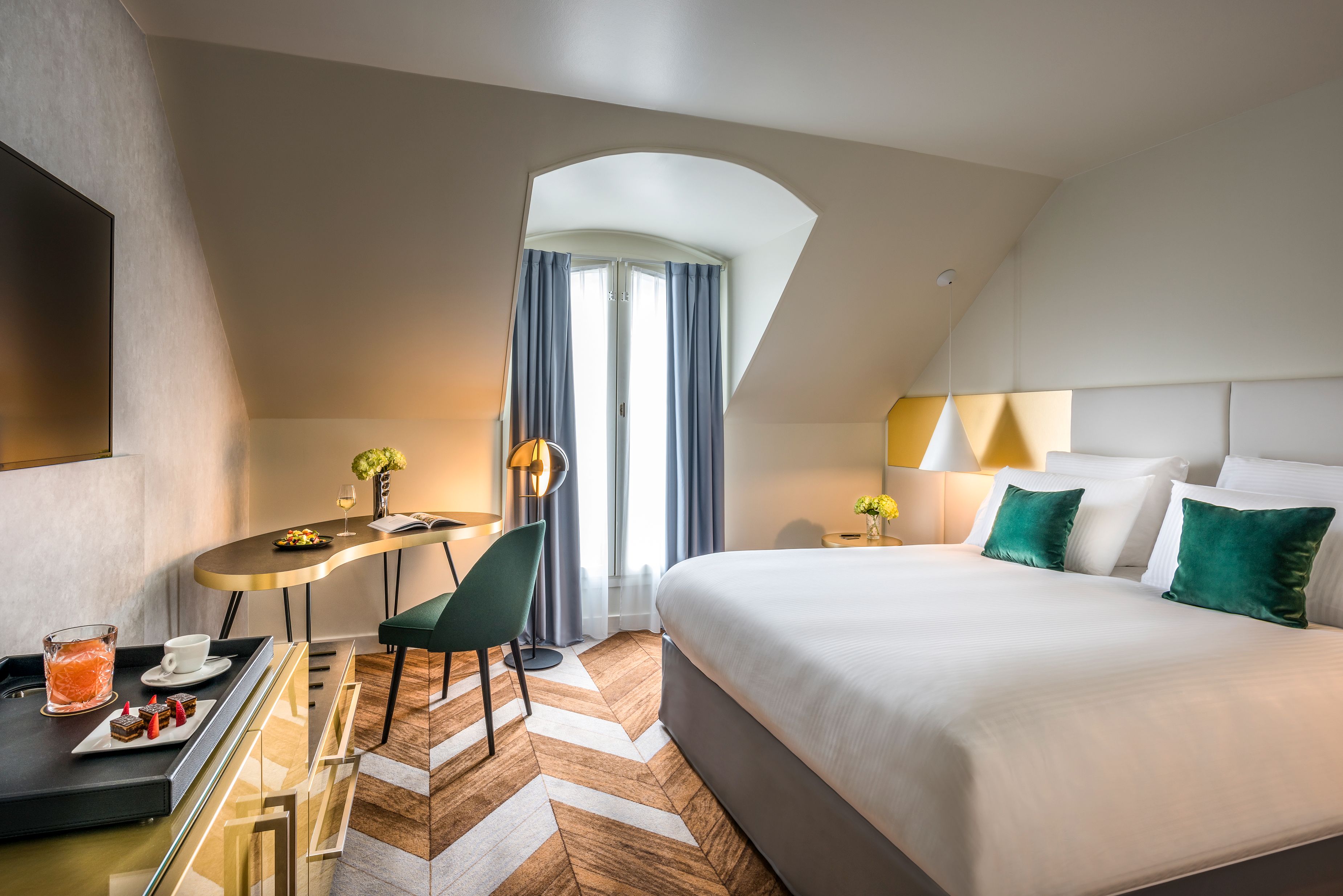 a bedroom with a desk and a bed