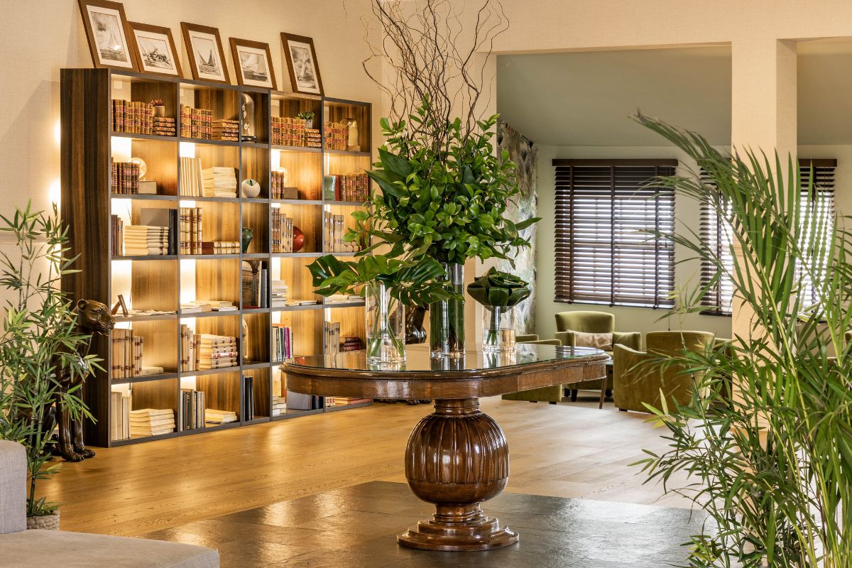 a room with a table and bookshelf