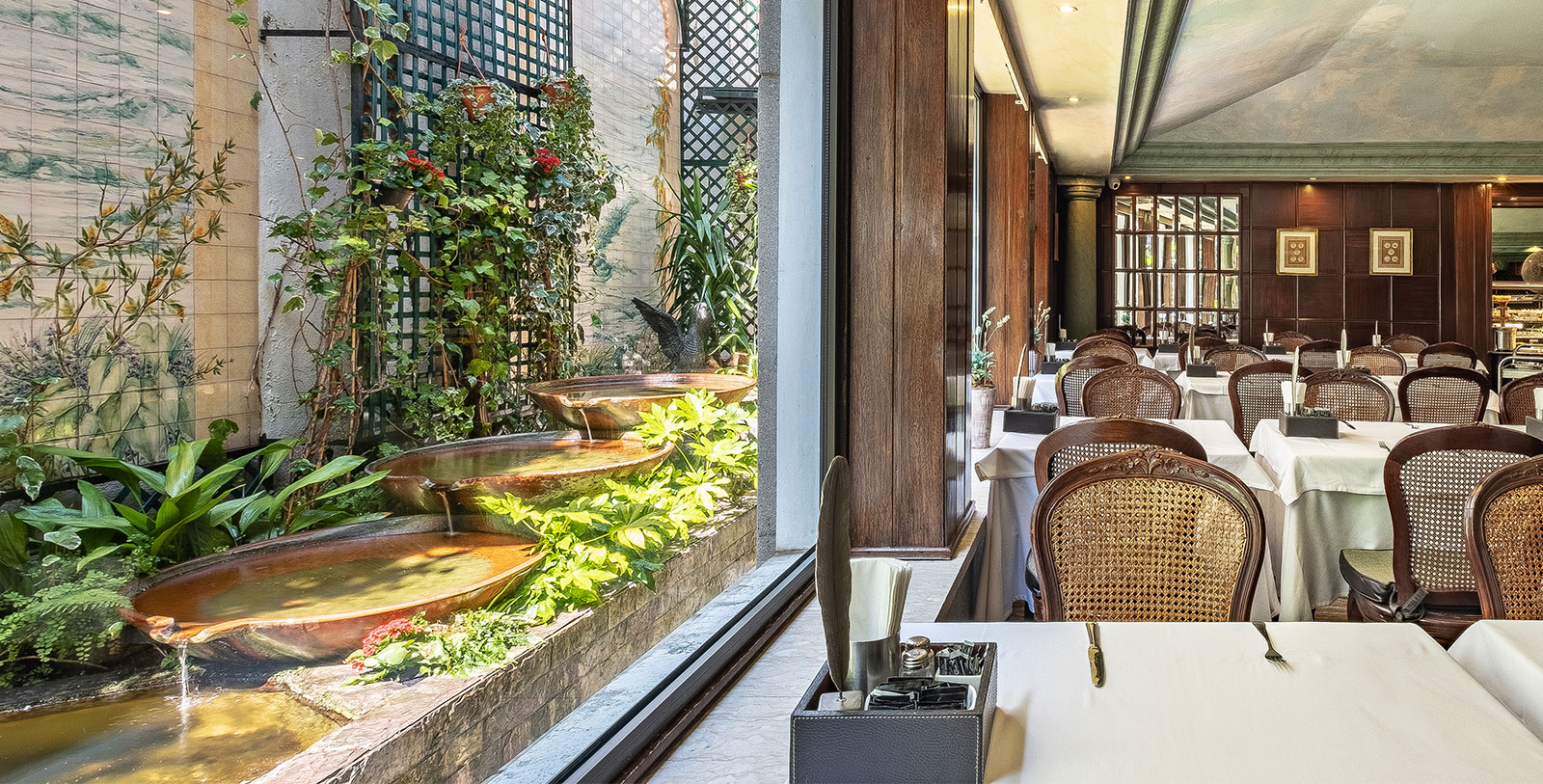 a room with a fountain and tables