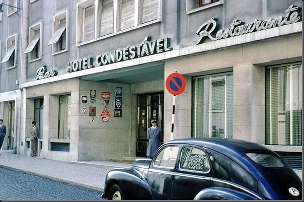 a black car parked in front of a hotel