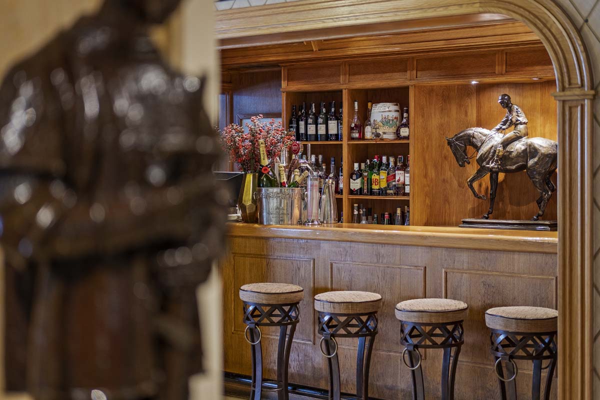 a bar with a statue of a horse on a shelf