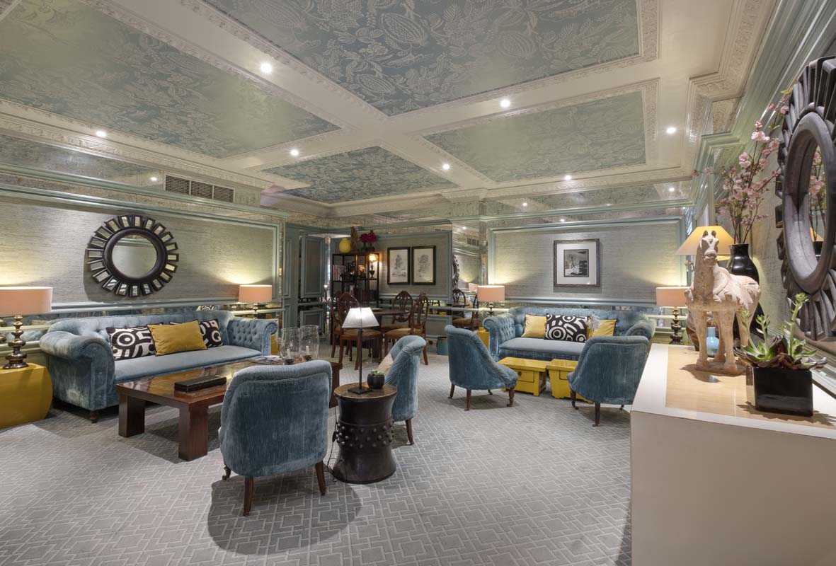 a room with blue furniture and a table