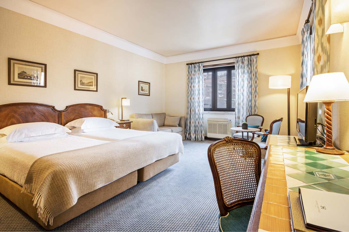 a hotel room with a table and chairs