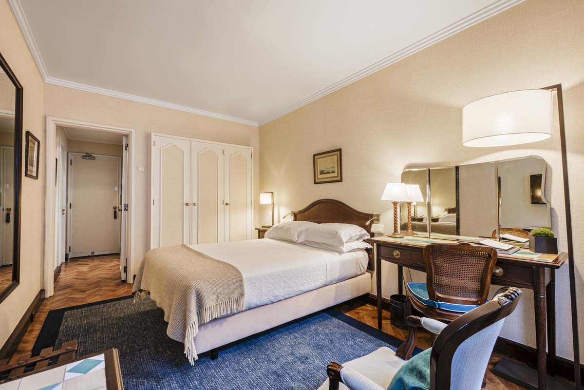 a bedroom with a bed and a mirror