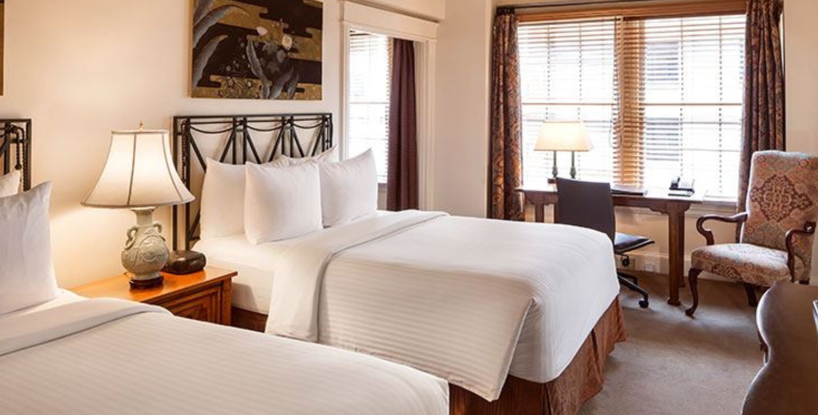 a room with two beds and a desk