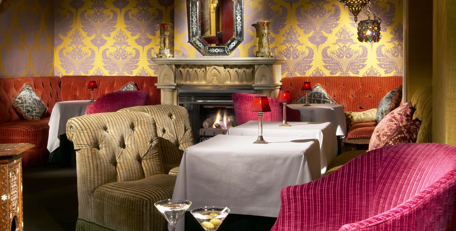 a room with a fireplace and tables