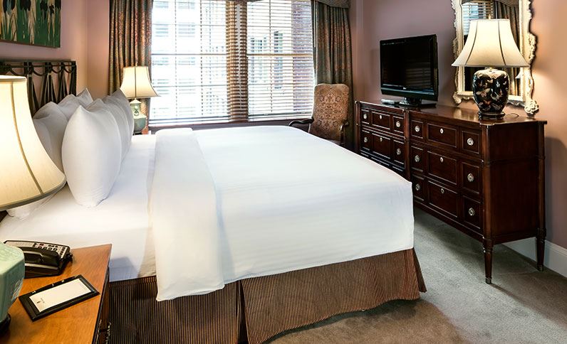 a bedroom with a bed and a tv