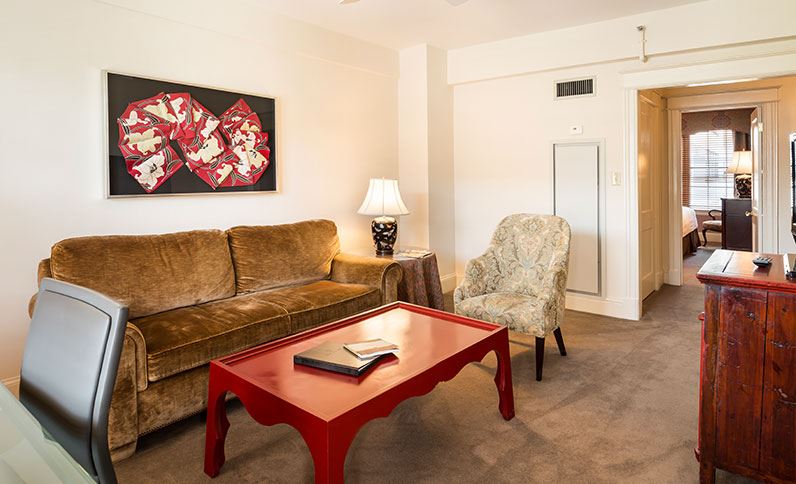 a living room with a couch and a red coffee table