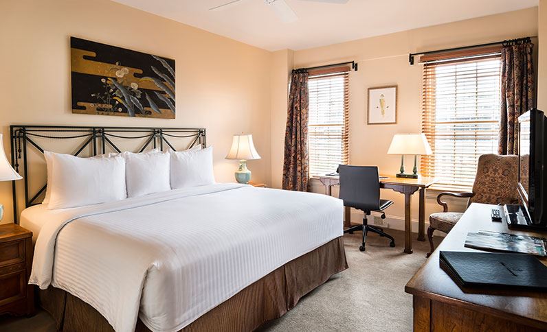 a room with a bed and desk