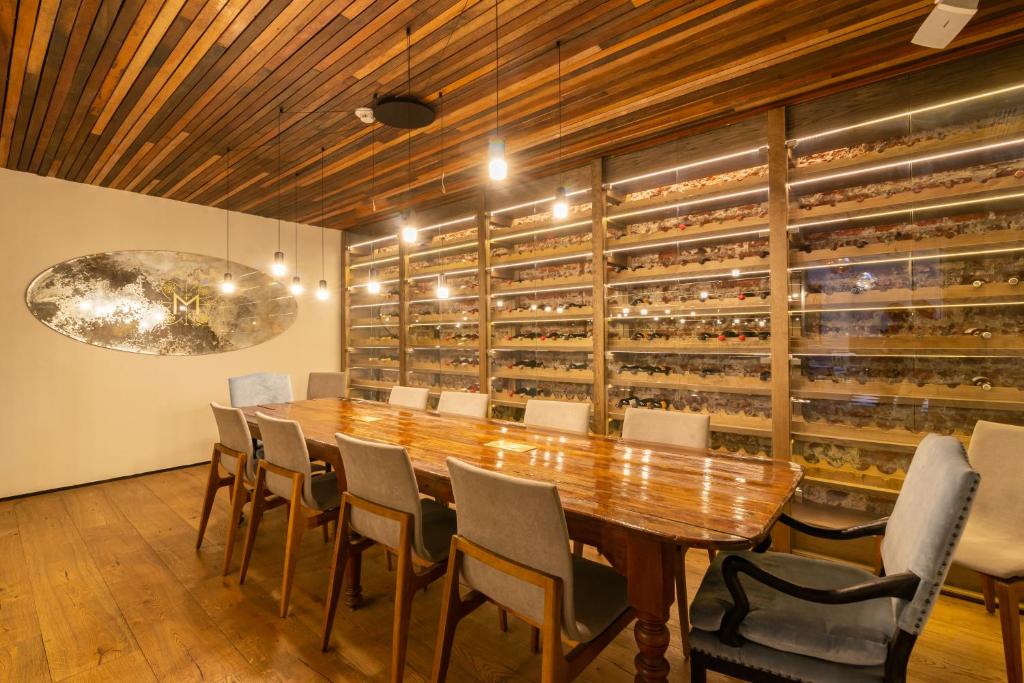 a table with chairs in a room with a wall of shelves
