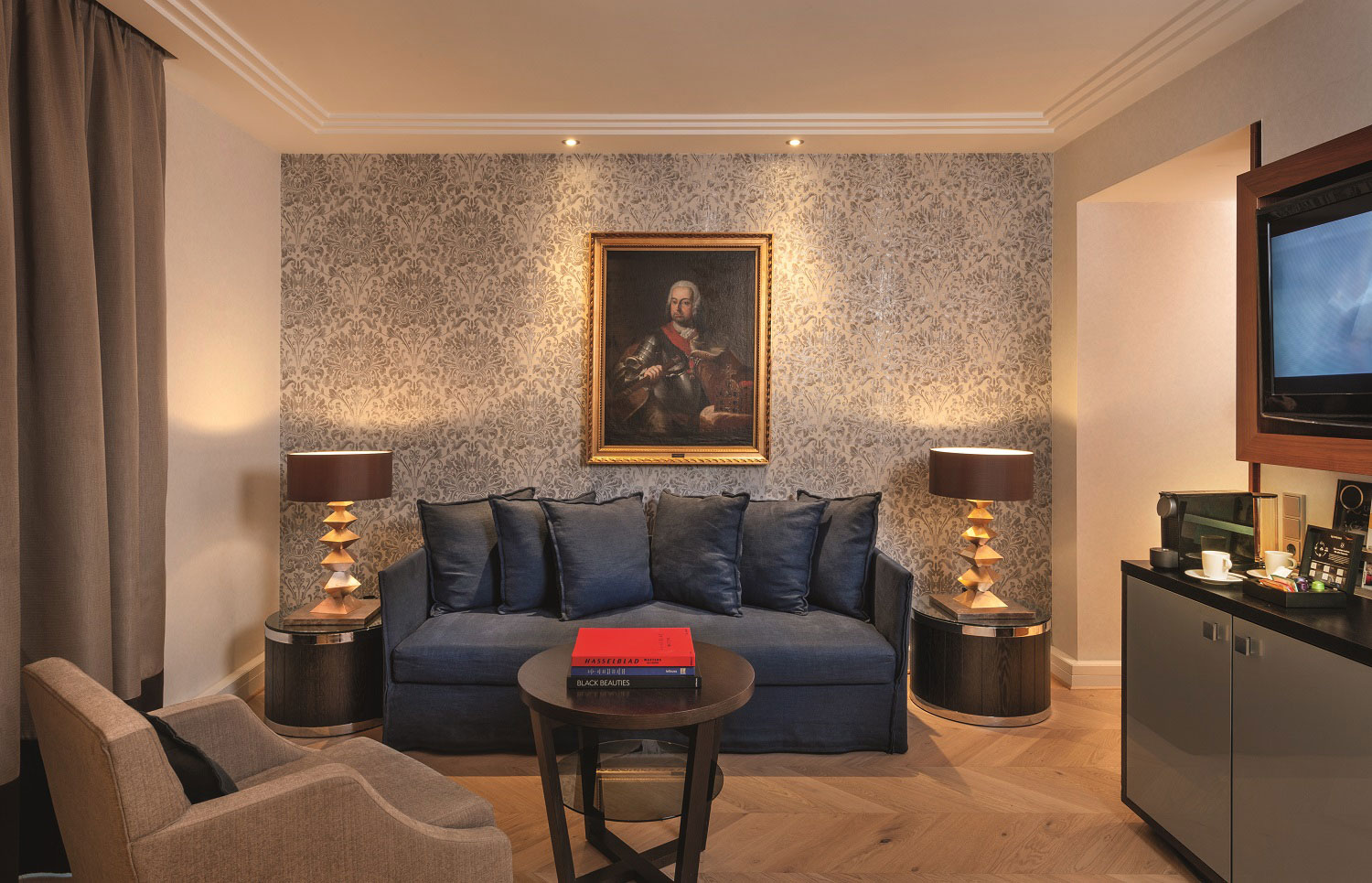 a living room with a couch and a painting on the wall