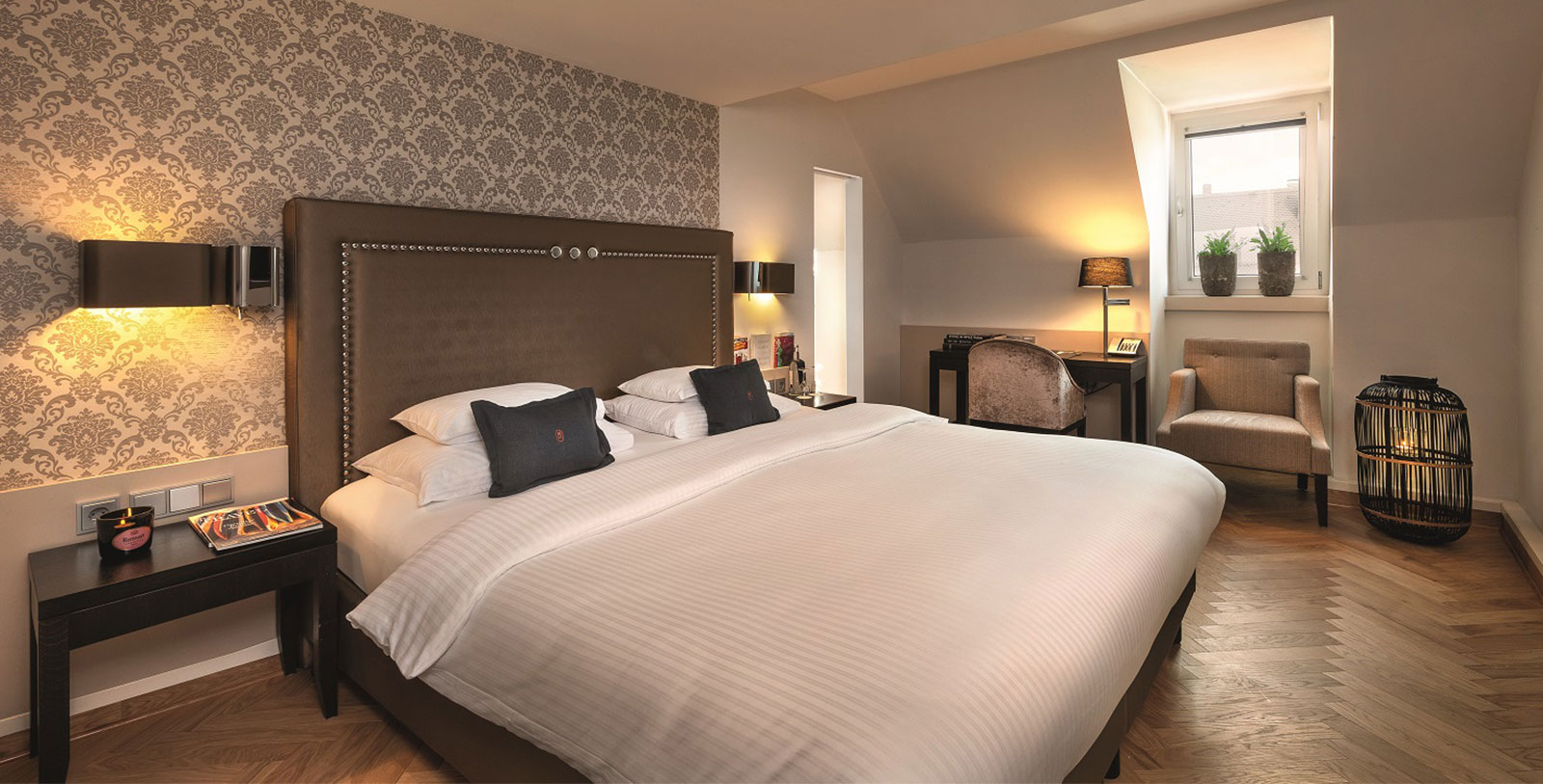 a bed with pillows and a desk in a room