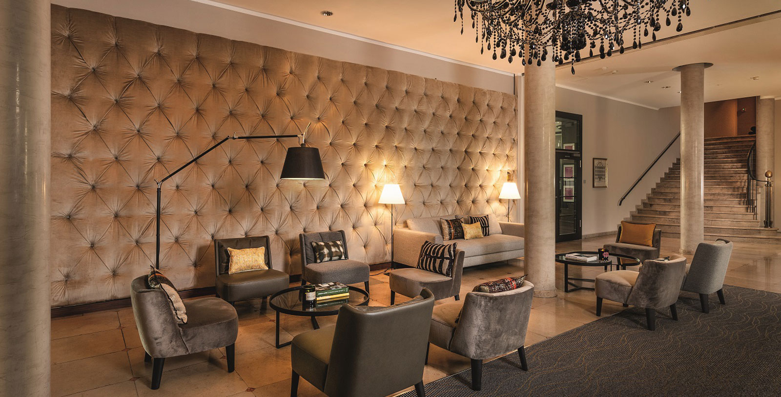a room with a chandelier and couches