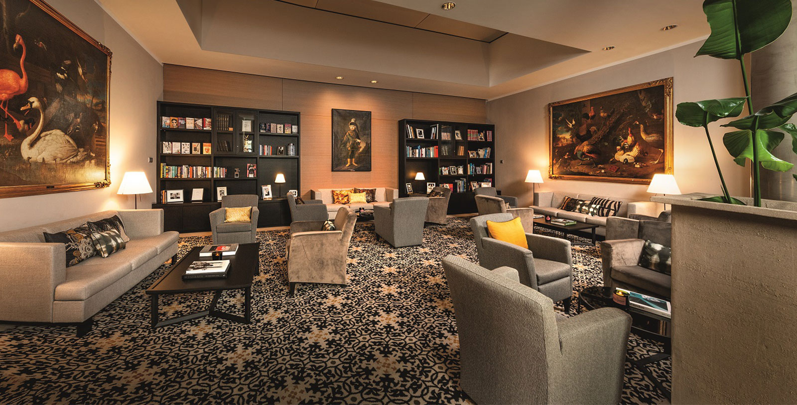 a room with a large area with chairs and a bookcase